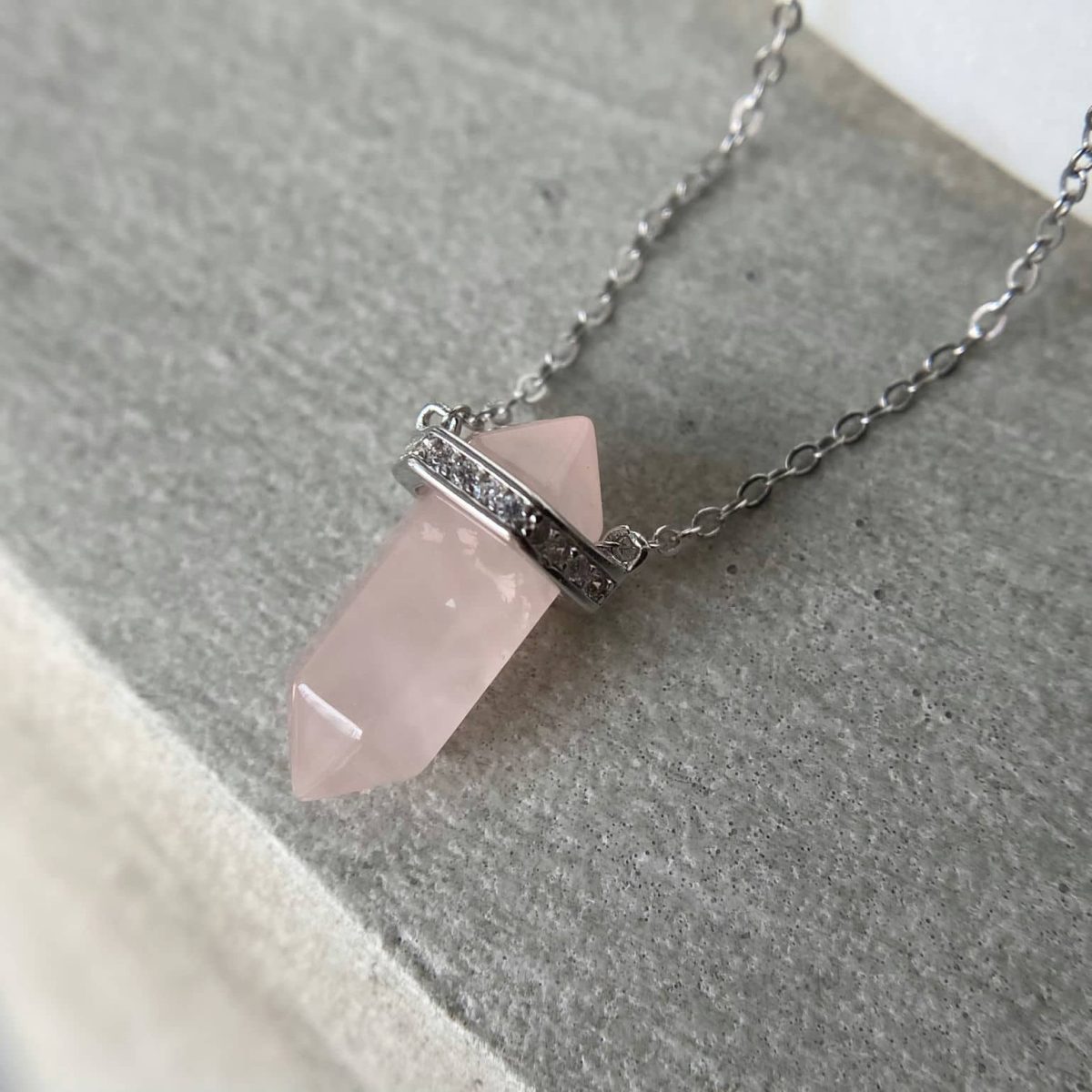 Made with genuine silver 925, this necklace features a beautiful rose quartz point pendant that exudes natural beauty and feminine charm.