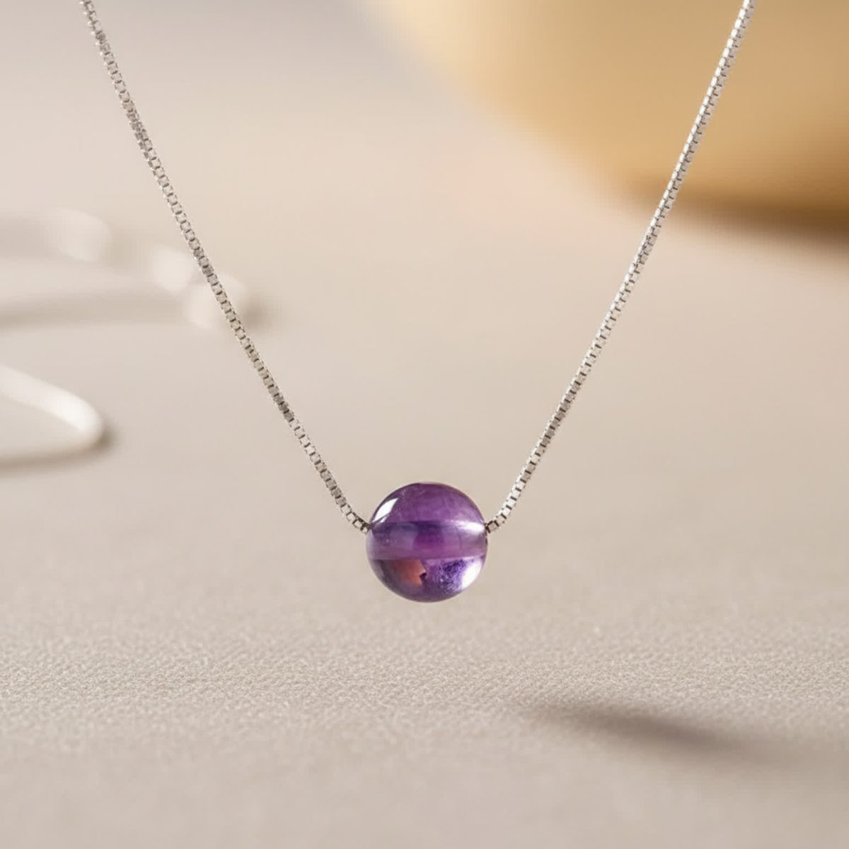 Sterling silver chain necklace with polished purple amethyst bead pendant