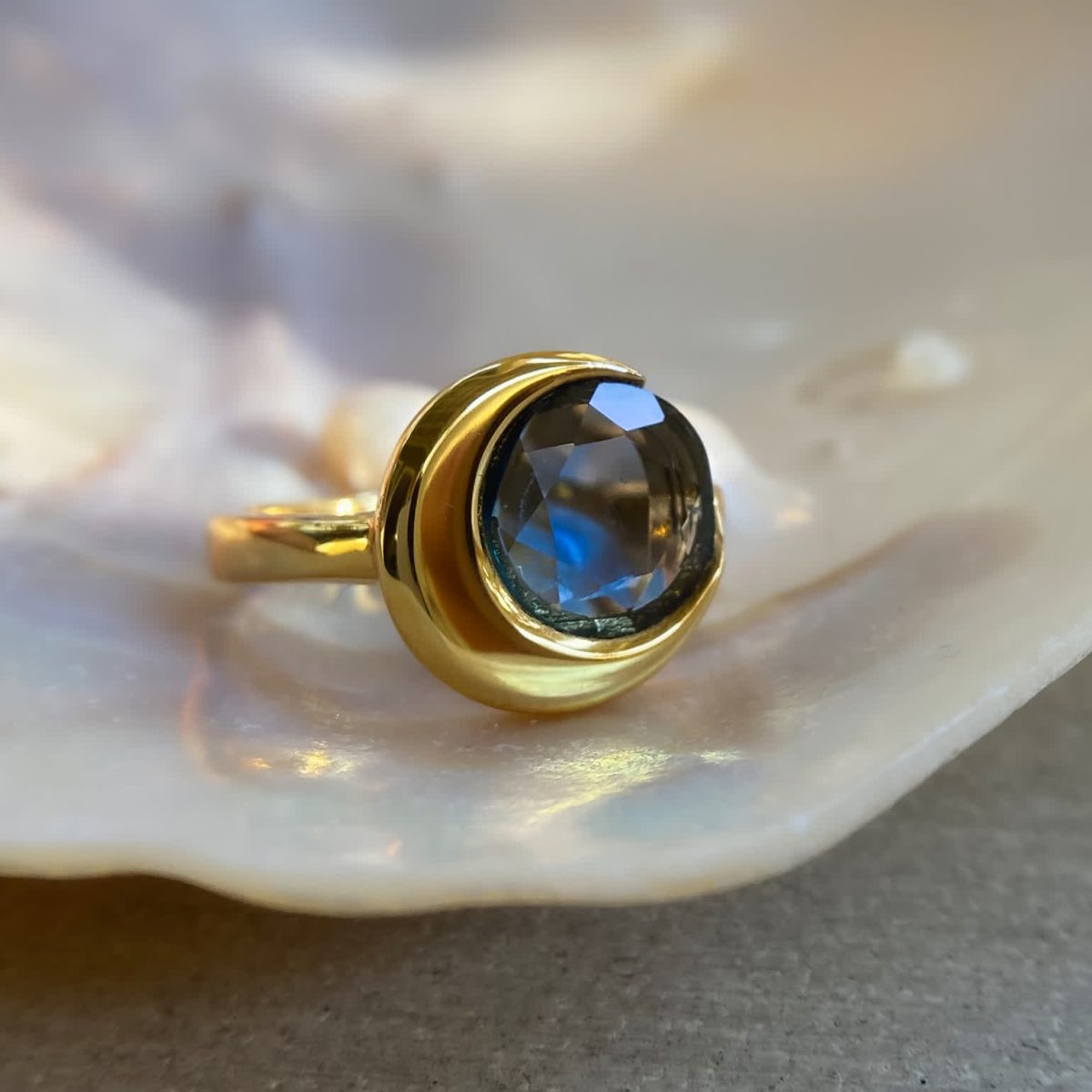 Vintage ring with london blue topaz displayed in velvet box with gold over silver band.