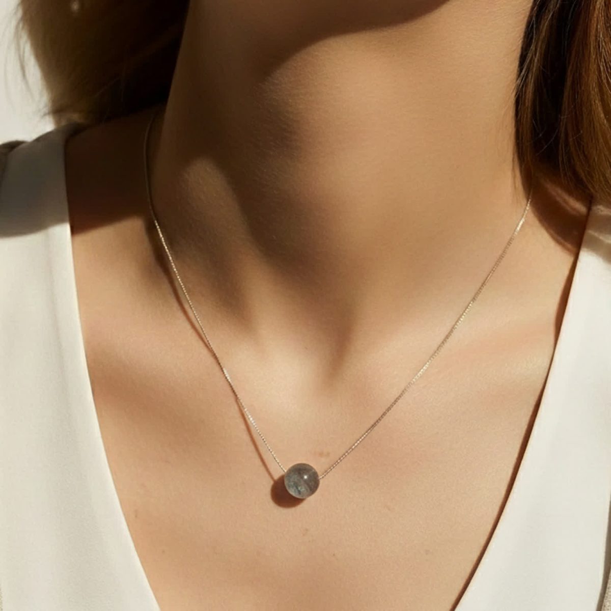 Delicate gemstone necklace featuring small round labradorite pendant