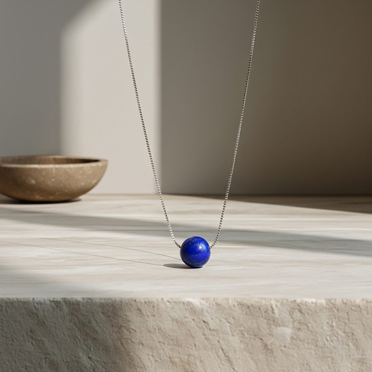 Lapis lazuli necklace silver displayed with small polished blue bead pendant