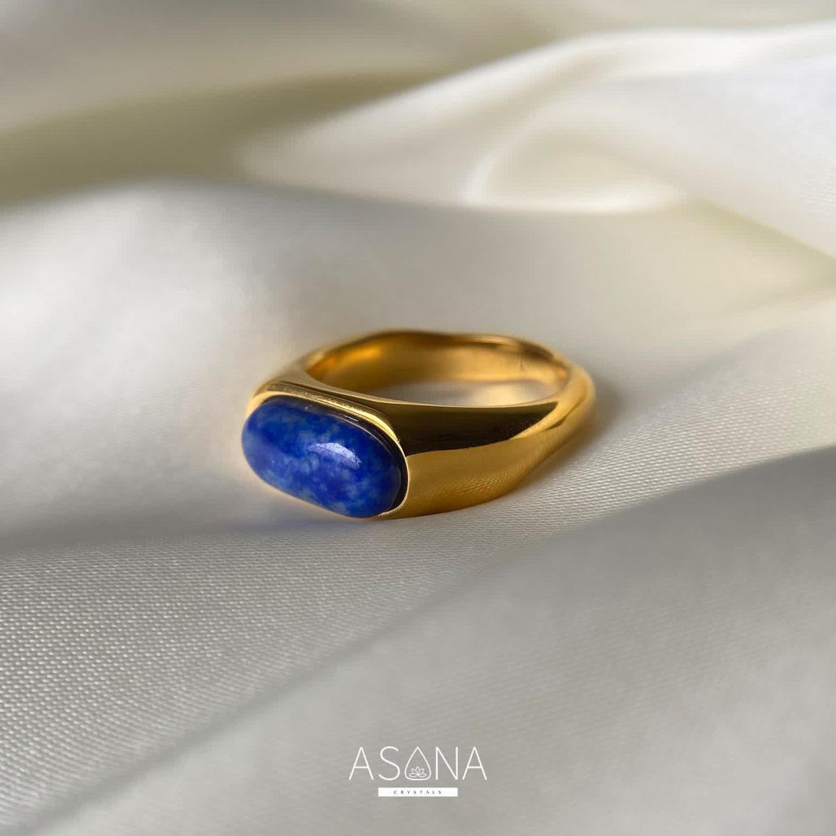 Front view of lapis lazuli ring highlighting oval cabochon stone and sleek metal setting.