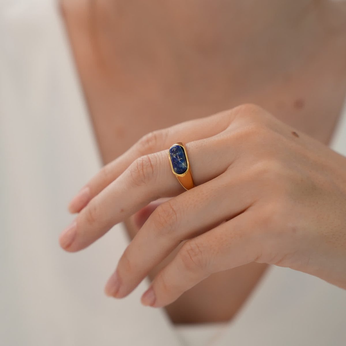 Hand wearing lapis lazuli ring demonstrating everyday fit and bold modern design.
