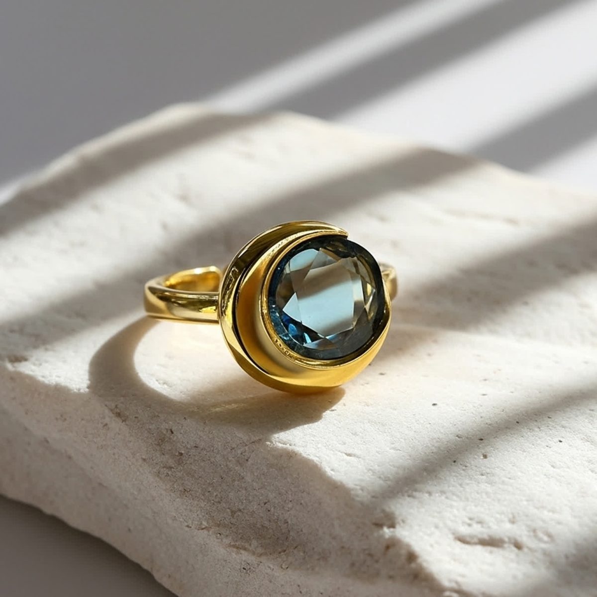 Front view of a london blue topaz ring with smooth gold setting and vintage feel.