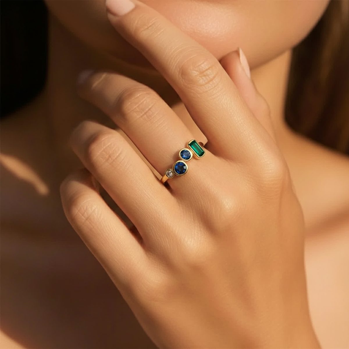 London blue topaz ring worn on hand showing irregular multi gemstone layout and modern celestial style.