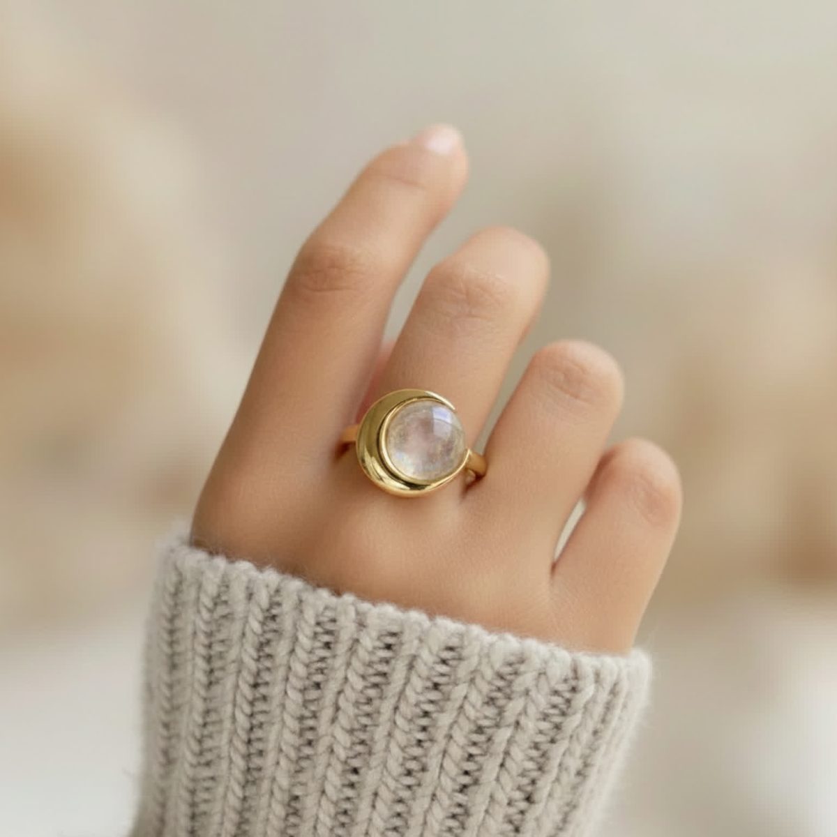 Moonstone ring worn on hand showing feminine celestial design and everyday scale.