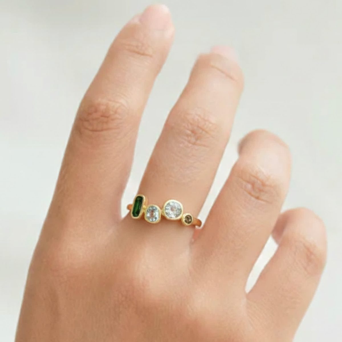 Multi-colored gemstone ring worn on hand showing balanced gemstone layout and slim everyday profile.