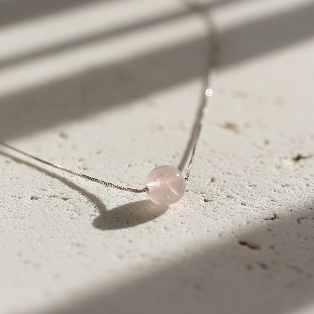 Minimalist necklace with rose quartz styled with white blouse