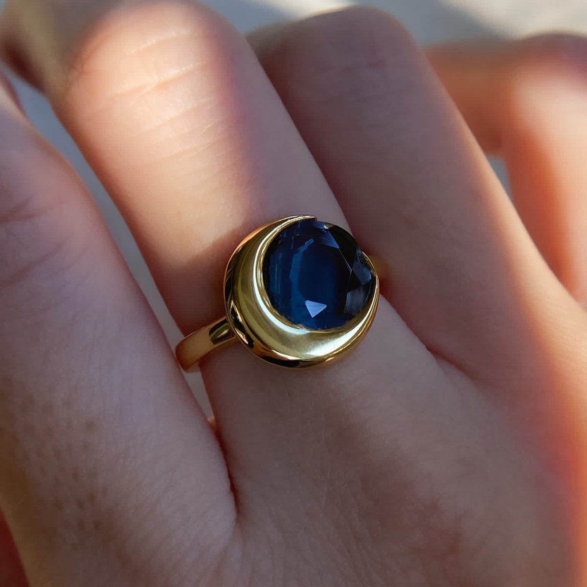 London blue topaz ring worn on hand showing moonlight glow and feminine proportions
